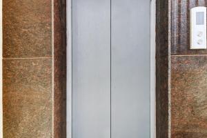 a door in a room with a wall at Dream Comforts Lodging & Boarding in Bengaluru
