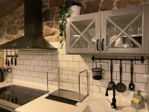 a kitchen with a sink and a counter top at Cabaña Pasiega El Ojal B in San Pedro del Romeral +49 photos
