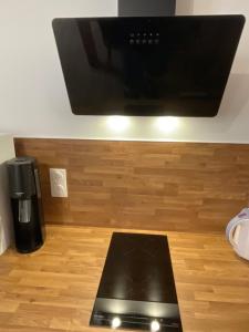 a flat screen tv sitting on top of a wooden floor at Cassandre in Montoire-sur-le-Loir