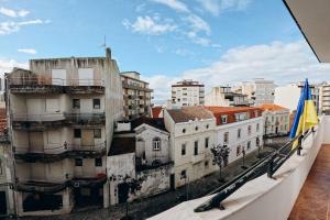 a view of a city from a balcony at Um pe na praia in Figueira da Foz