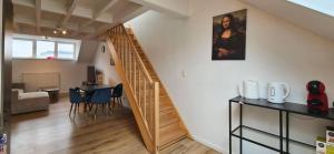 a room with a staircase and a table and chairs at Blu shell house in Brussels