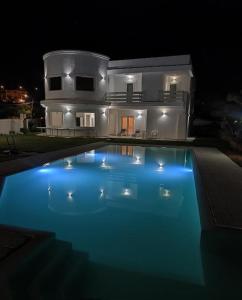 a swimming pool in front of a house at night at Al Mare da Francesca in Olbia
