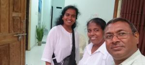 a group of three people posing for a picture at Budha ashram guest house in Bodh Gaya
