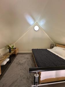 a bedroom with a bed and a ceiling at Ambra Maldives in Thoddoo