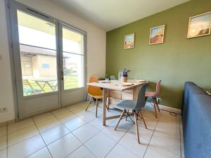 a dining room with a table and chairs at Les Gemmeurs - T2 proche du lac in Aureilhan