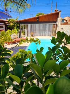 una piscina nel cortile di una casa di Luz Residence suíte a Cabo Frio Altre 9 foto
