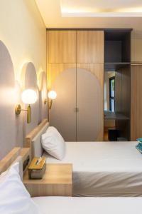 a hotel room with a bed and two lamps at Rasafie Dago Villa in Bandung