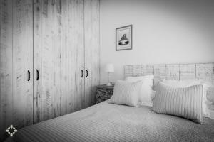 a bedroom with a bed and a wooden cabinet at Villa Mar Coral by Abahana Luxe in Moraira