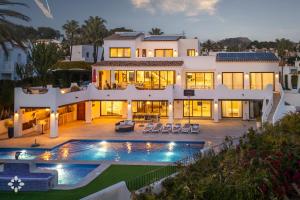 a large house with a swimming pool in front of it at Villa Mar Coral by Abahana Luxe in Moraira