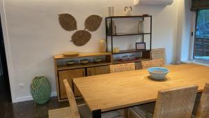 a dining room with a wooden table and chairs at Eden Mar Sant Antoni de Calonge in Sant Antoni de Calonge