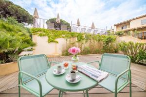 a table and two chairs on a patio at Les Capucines Saint Tropez in Saint-Tropez