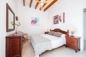 a bedroom with a bed and a desk and a mirror at Can Pascual Gran in Manacor +28 photos