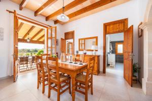 a dining room with a wooden table and chairs at Can Pascual Gran in Manacor
