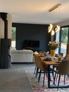 a living room with a wooden table and chairs at Villa du Golf in Baden