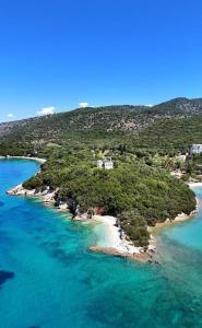 an island in the ocean with a house on it at Villa Rodanthi Sivota in Syvota