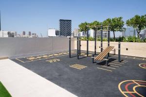a playground with a bench on top of a building at Elegant 1br Apt In Jvc With Spacious Balcony in Dubai