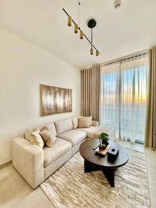 a living room with a couch and a table at Elegant 1br Apt In Jvc With Spacious Balcony in Dubai