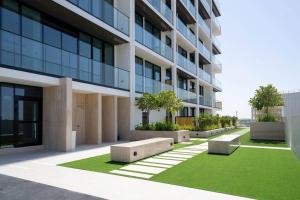 an office building with benches in front of it at Elegant 1br Apt In Jvc With Spacious Balcony in Dubai