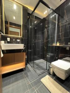 a bathroom with a shower and a toilet and a sink at Elegant 1br Apt In Jvc With Spacious Balcony in Dubai