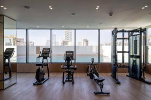 a gym with several exercise equipment in a building at Elegant 1br Apt In Jvc With Spacious Balcony in Dubai