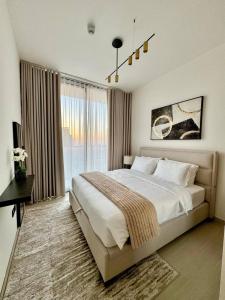 a bedroom with a large bed and a large window at Elegant 1br Apt In Jvc With Spacious Balcony in Dubai