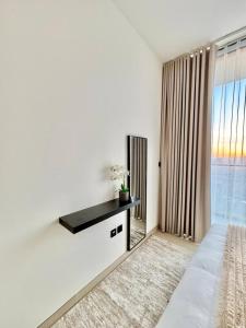 a bedroom with a bed and a large window at Elegant 1br Apt In Jvc With Spacious Balcony in Dubai