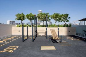 a playground with two wooden chairs in a parking lot at Elegant 1br Apt In Jvc With Spacious Balcony in Dubai