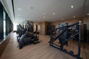 a gym with treadmills and cardio equipment in a building at Elegant 1br Apt In Jvc With Spacious Balcony in Dubai