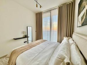 a bedroom with a bed and a large window at Elegant 1br Apt In Jvc With Spacious Balcony in Dubai