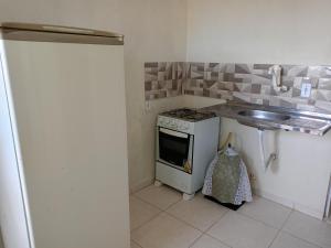a kitchen with a stove and a sink at Lugar de paz in Marataizes +4 photos