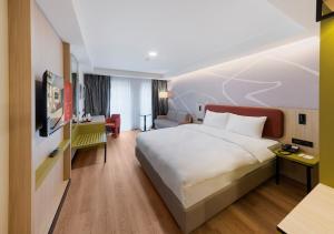 a hotel room with a large bed and a living room at Noém Hotel in Erzurum