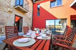 a wooden table with plates of food on a patio at Villa Mit Viel Platz Und Pool In Vila Cova in Gemeses