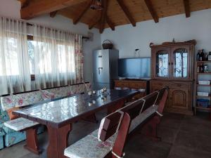 a dining room with a table and chairs and a refrigerator at Apartments Biserka G in Palit