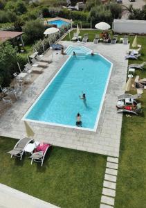 a group of people in a swimming pool at Al Mare da Francesca in Olbia