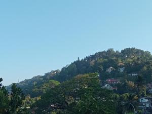 a mountain with houses on a hill at Kandy Horizon Homestay in Kandy