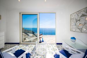 a living room with a view of the ocean at Grand Hotel Tritone in Praiano