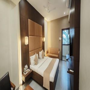 a hotel room with a bed and a chair at Raj Regency in Vilad +46 photos