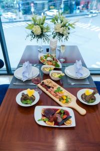 a wooden table with plates of food on it at SANDALS ISLAND HOTEL in Nha Trang +127 photos