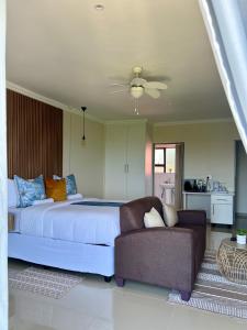 a bedroom with a large bed and a couch at Montrose BnB in Margate