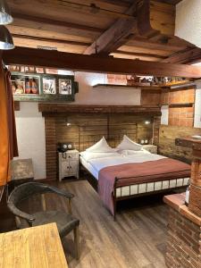 a bedroom with a large bed in a room with wooden ceilings at Romantik Hotel U Raka in Prague