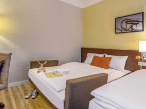 Postel nebo postele na pokoji v ubytování Mercure Hotel Duisburg City