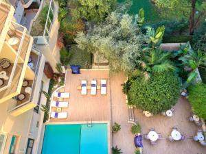 an overhead view of a courtyard with a swimming pool at Croisette Beach Hotel Cannes - MGallery Collection in Cannes