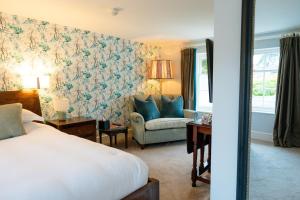 a hotel room with a bed and a chair at The Ollerod in Beaminster +120 photos