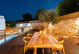 a wooden table with chairs on a deck at Excesio in Gerani
