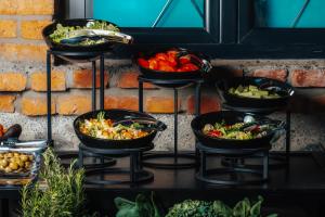a group of bowls of vegetables on a shelf at Samzeo Kvareli in Kvareli