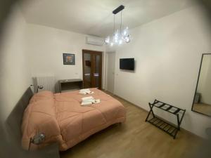 a bedroom with a bed with towels on it at Le Ninfe Guest House in Cisterna di Latina