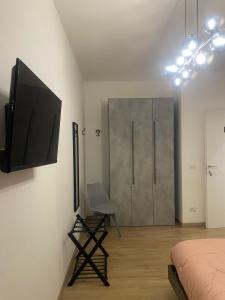 a bedroom with a bed and a television on the wall at Le Ninfe Guest House in Cisterna di Latina +22 photos