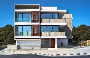 a modern house with a lot of windows at Avenue 201 2 BED in Paphos
