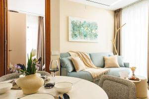 a living room with a blue couch and a table at Corral del Carbón GG Luxury Hotel Boutique in Granada +107 photos