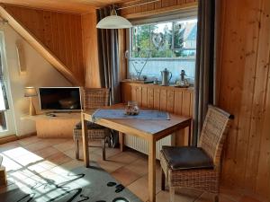 cocina con mesa y TV en una habitación en Fewo Holzwurm, en Braunlage